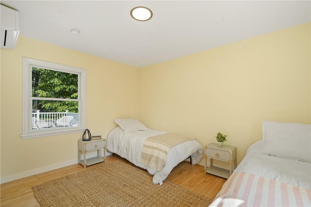 bedroom with baseboards and wood finished floors