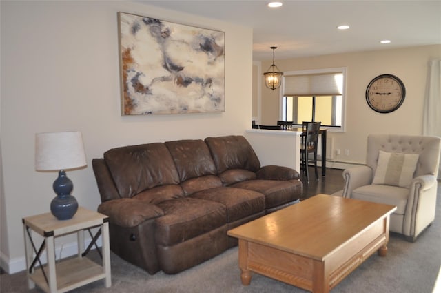 carpeted living room with a baseboard radiator and an inviting chandelier