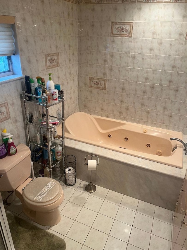 bathroom featuring a relaxing tiled tub, tile walls, tile patterned floors, and toilet