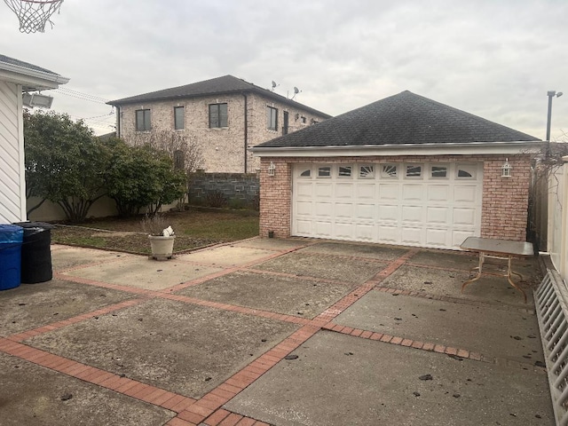 view of property exterior with a garage and an outbuilding