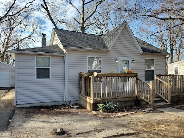 back of house with a deck