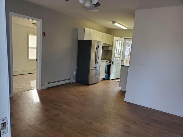 kitchen featuring hardwood / wood-style flooring, ceiling fan, baseboard heating, white cabinetry, and stainless steel appliances