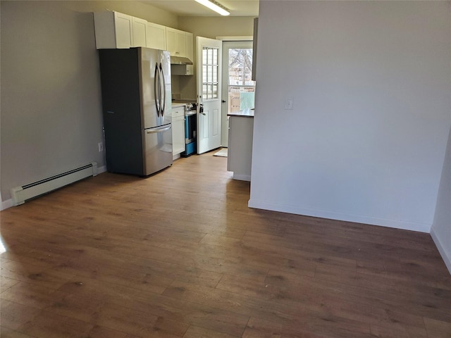 kitchen with stainless steel appliances, a baseboard radiator, dark hardwood / wood-style flooring, and white cabinetry