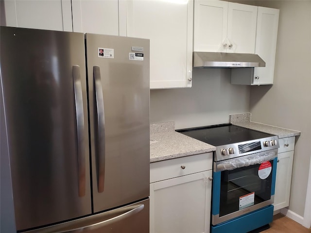 kitchen with appliances with stainless steel finishes, light stone countertops, and white cabinets