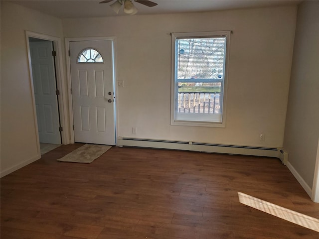 foyer entrance with hardwood / wood-style flooring, ceiling fan, and baseboard heating