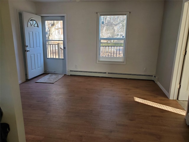 entrance foyer with a baseboard radiator, dark hardwood / wood-style flooring, and a wealth of natural light