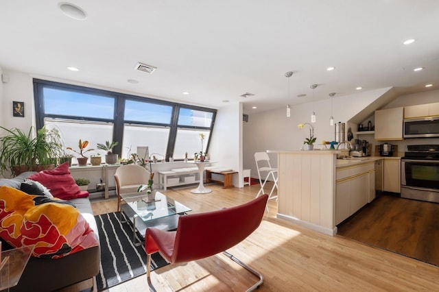 living room with sink and light wood-type flooring