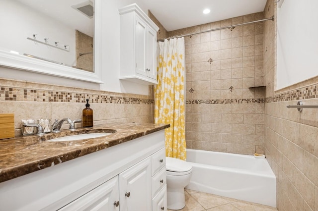 full bathroom with tile walls, vanity, toilet, shower / bathtub combination with curtain, and tile patterned floors