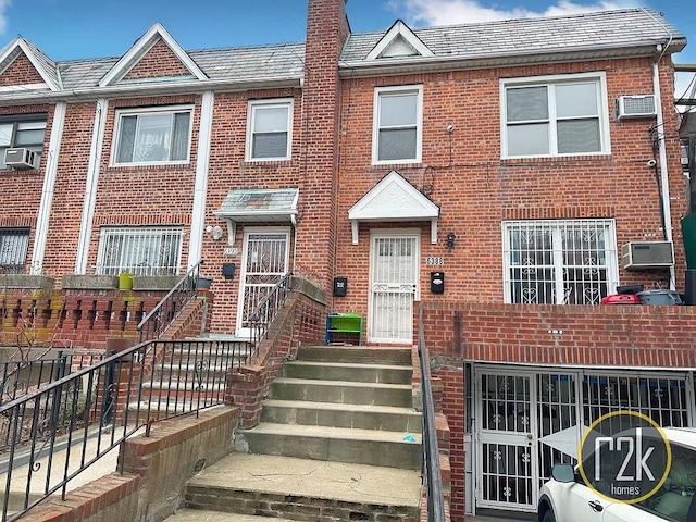 view of property featuring cooling unit and a wall mounted air conditioner