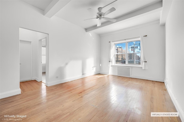 empty room featuring beamed ceiling, ceiling fan, and light hardwood / wood-style flooring