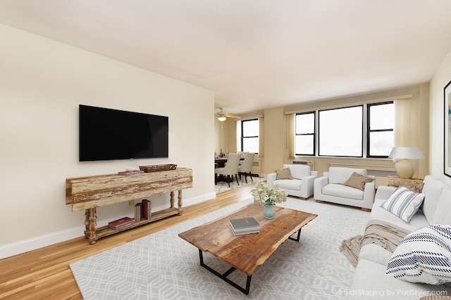 living room with wood-type flooring and ceiling fan