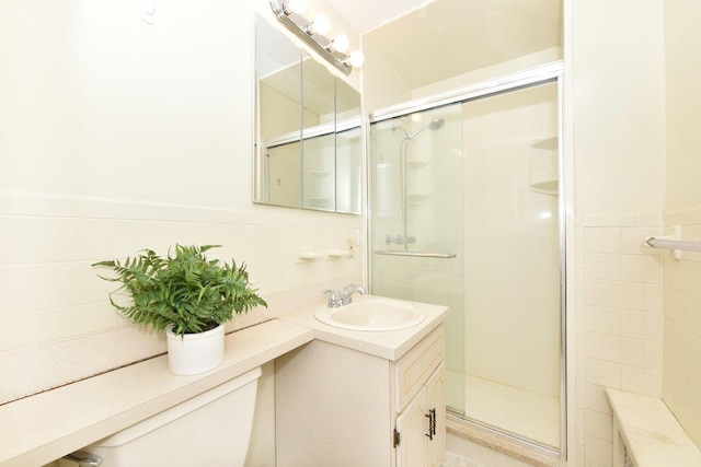 bathroom with vanity, tile walls, and an enclosed shower