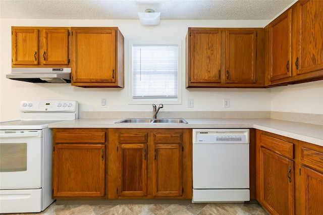 kitchen featuring sink, white appliances, and a textured ceiling