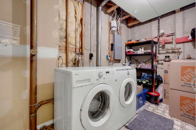 laundry room with washing machine and clothes dryer and electric panel