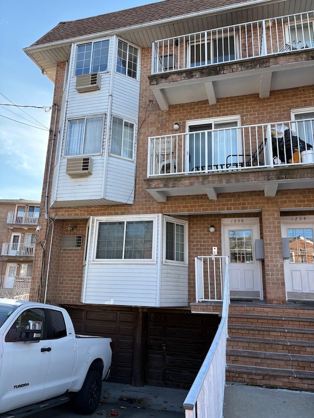 view of building exterior featuring a wall mounted AC