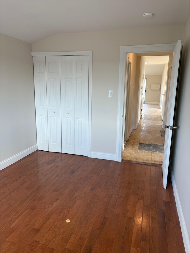 unfurnished bedroom featuring dark hardwood / wood-style floors and a closet