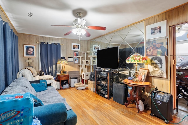 living room featuring crown molding, hardwood / wood-style floors, and ceiling fan