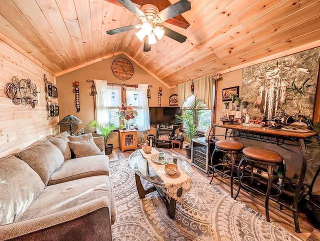 living room with hardwood / wood-style flooring, lofted ceiling, a wood stove, and wooden ceiling