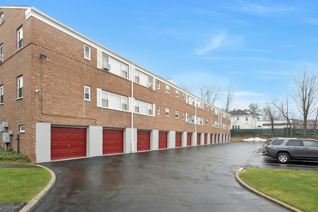 view of property featuring cooling unit and a garage