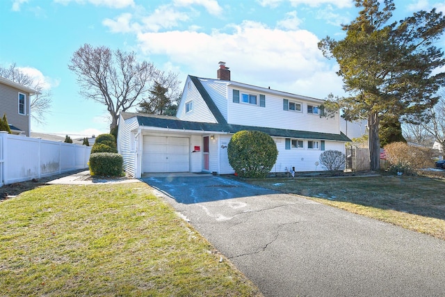 front facade featuring a garage and a front yard