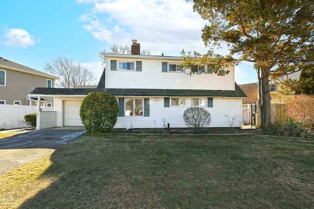 view of front of home with a garage and a front lawn