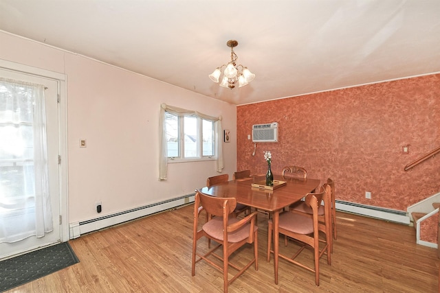 dining area with a chandelier, a wall mounted AC, hardwood / wood-style floors, and a baseboard heating unit