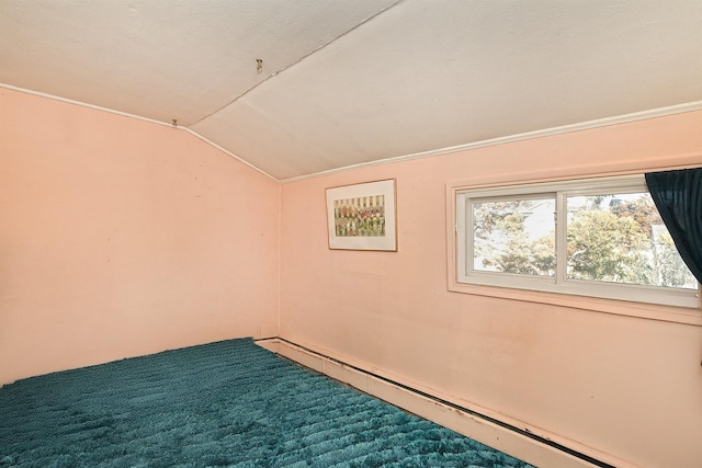 interior space featuring vaulted ceiling and a baseboard heating unit