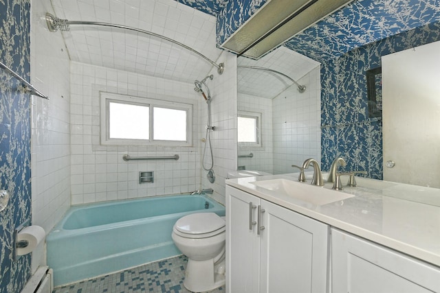 full bathroom featuring tiled shower / bath, vanity, baseboard heating, and toilet