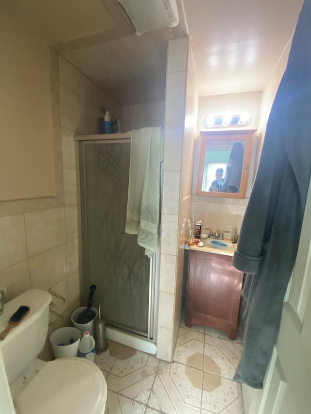 bathroom with tile walls, decorative backsplash, a shower with door, and toilet