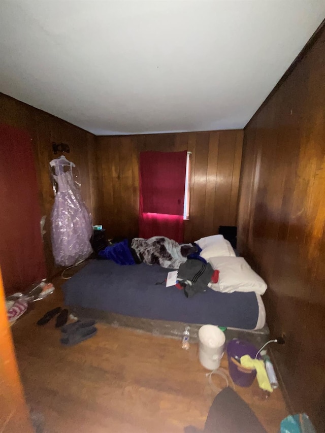 bedroom featuring wooden walls