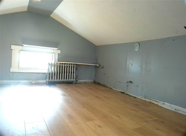 bonus room with lofted ceiling and light hardwood / wood-style floors