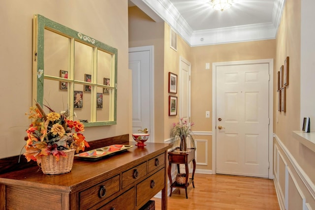 interior space featuring crown molding and light hardwood / wood-style flooring