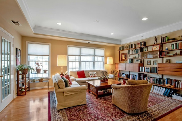 sitting room with hardwood / wood-style flooring, crown molding, and plenty of natural light