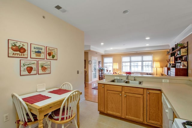 kitchen featuring dishwasher, sink, ornamental molding, range, and kitchen peninsula