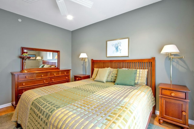 bedroom with ceiling fan and light wood-type flooring