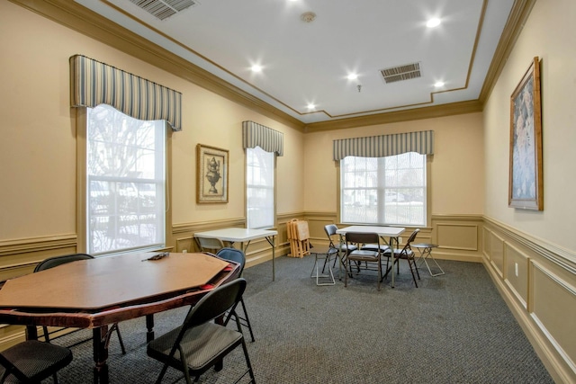 carpeted dining room featuring crown molding