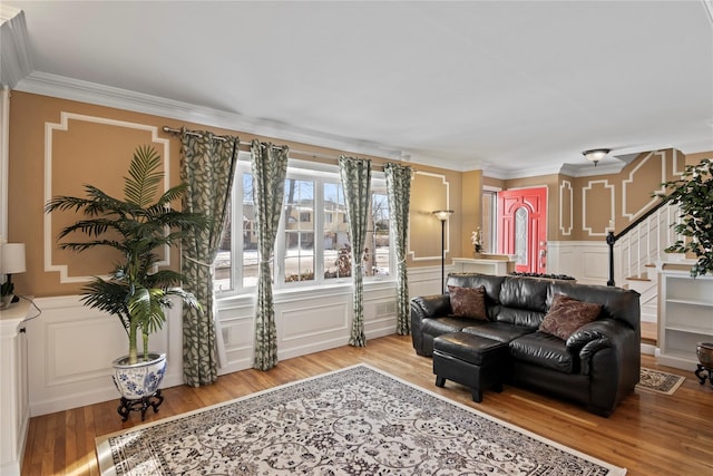 living room with light hardwood / wood-style flooring and ornamental molding