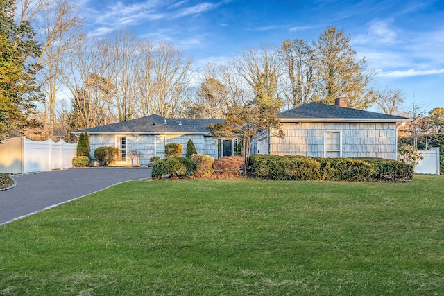 ranch-style house with a front lawn