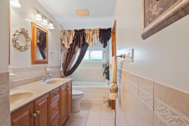 bathroom with toilet, tile walls, vanity, tile patterned flooring, and a washtub