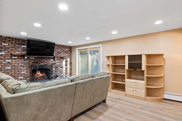 living room with light hardwood / wood-style flooring and a fireplace