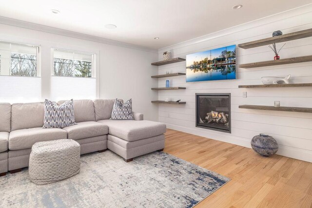 155 Pinewood Rd, Cutchogue, NY 11935 - living room featuring ornamental molding, wood finished floors, and a large fireplace