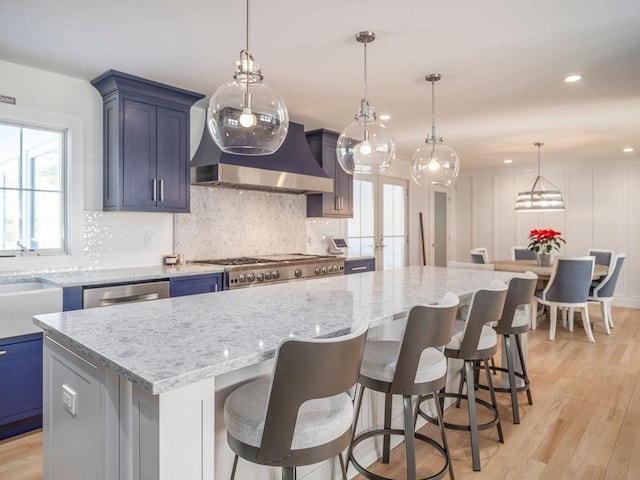 155 Pinewood Rd, Cutchogue, NY 11935 - kitchen featuring custom range hood, a kitchen island, light stone countertops, and tasteful backsplash