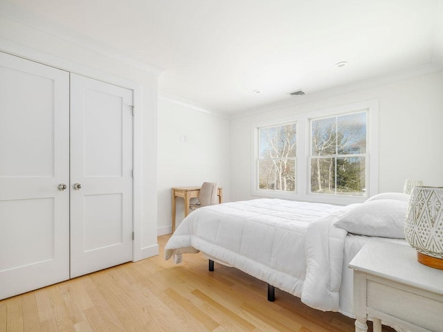 155 Pinewood Rd, Cutchogue, NY 11935 - bedroom featuring visible vents, crown molding, a closet, wood finished floors, and baseboards