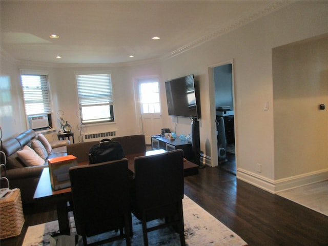 dining room with cooling unit, radiator, crown molding, and dark hardwood / wood-style floors