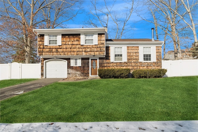 split level home featuring a garage and a front lawn