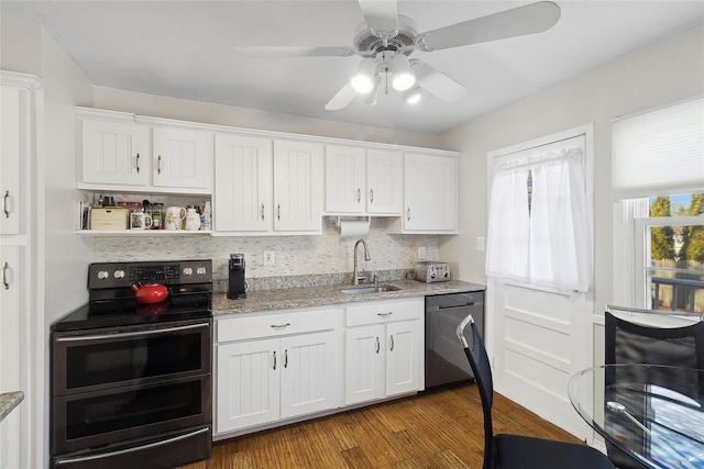 kitchen with dishwasher, white cabinets, and range with two ovens