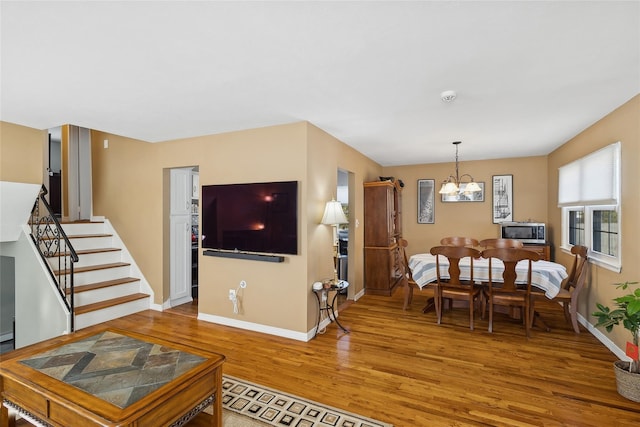 living room with hardwood / wood-style floors and a chandelier