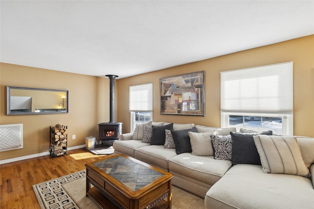 living room featuring a wood stove and hardwood / wood-style floors