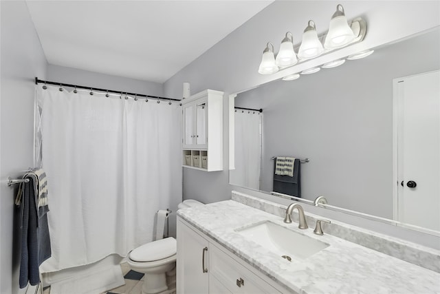 bathroom featuring vanity, toilet, and tile patterned flooring