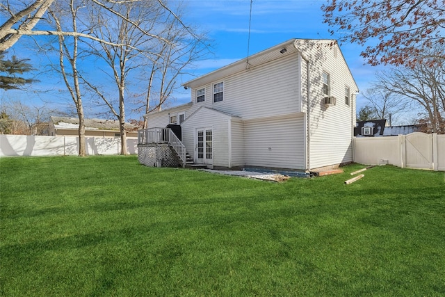 rear view of property with a yard and a deck